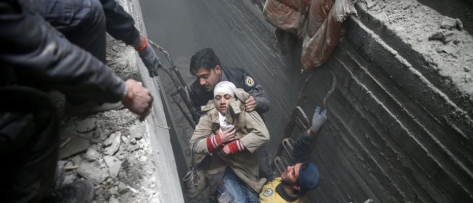 Syria Civil Defense members help an unconscious woman from a shelter in the besieged town of Douma, Eastern Ghouta, Damascus, Syria, Feb. 22, 2018.   Syrians in Ghouta Tweet for Their Lives as Bombs Rain Down  “For God’s sake help us!” reads a message on Twitter attached to a video showing two small girls, bleeding and crying in a smoky, chaotic house. It is part of a social media campaign surrounding the crisis in Ghouta, Syria, where more than 400 civilians have been killed in the past six days, according