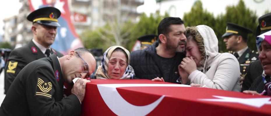 Family members mourn over the coffin of Ugur Palanci, 28, during a funeral ceremony in Izmir, Turkey, March 2, 2018. Taha Palanci was one of eight Turkish soldiers killed Thursday in fighting against Syrian Kurdish militia in Afrin, northwestern Syria.